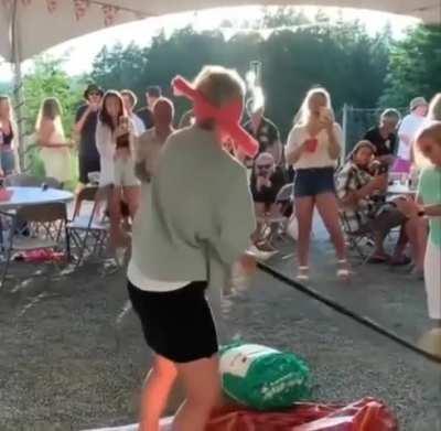 The way this lady stands right in the dangerous spot and the way the stick bends!