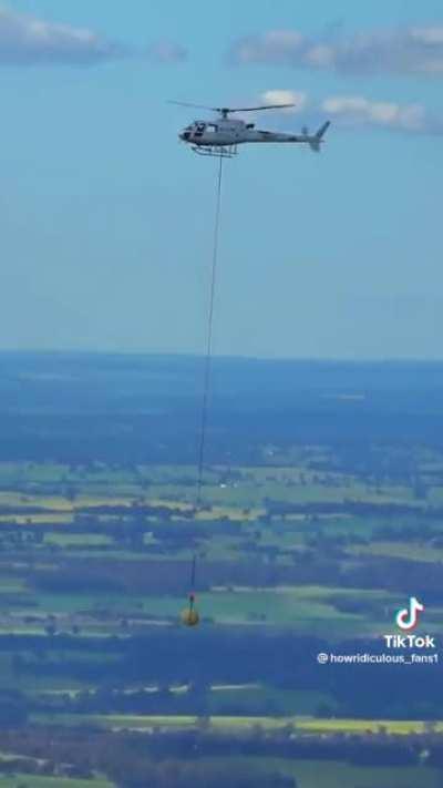 Dropping a massive rubber band ball from a helicopter