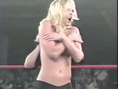 Getting her top removed during a wrestling match