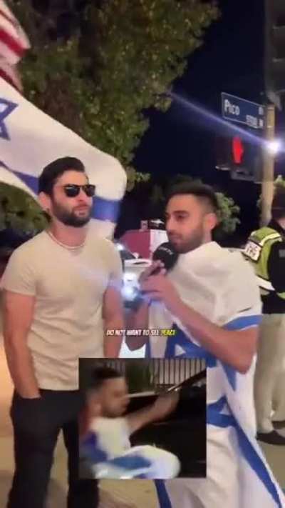 Israeli protestor talks the talk into the microphone, but 10 seconds later fails to walk the walk.