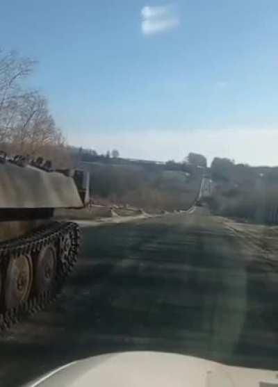Russian tank runs out of fuel, gets stuck on a highway. Driver offers to take the soldiers back to Russia. Everyone laughs. Driver tells them that Ukraine is winning, Russian forces are surrendering and implies they should surrender as well.
