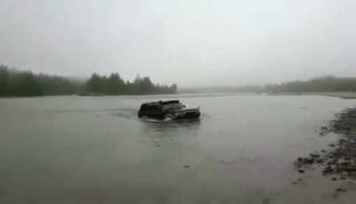 Russians driving their SUV in river for fun..