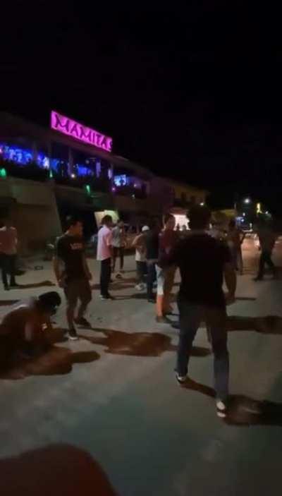 Latin America street fight with cumbia music & Spanish soccer announcer.