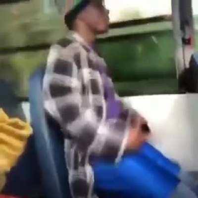 Blackkk man sitting in Public transport