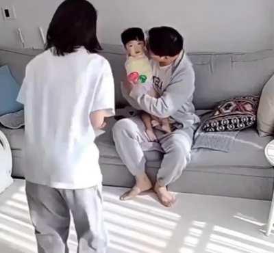 Parents watching their kid take his first steps