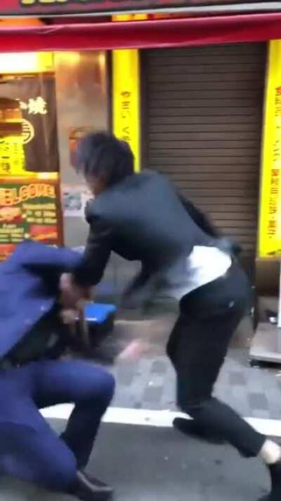 Japanese guy gets hit over the head with a stool