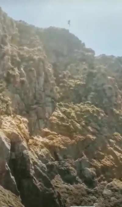 Don't jump off a cliff this high into water unless you're a professional.