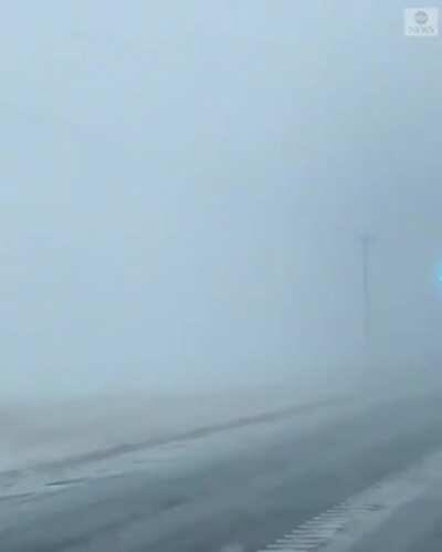 Power lines creating an arc in a blizzard