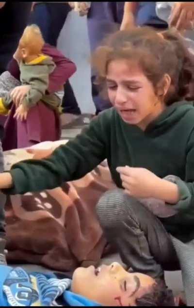 Palestinian Girl Comforts Her Grieving Brother Over Their Sibling's Passing: 