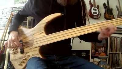 Dutch bassist Remco Hendriks playing a fretless bass, with finger style dubbed lobster claw.