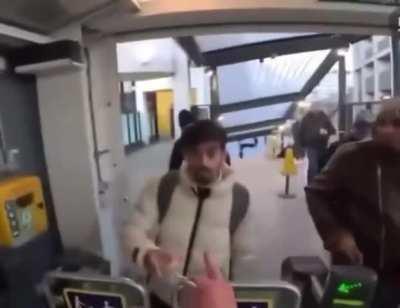 Man stops freeloaders shuffling behind him