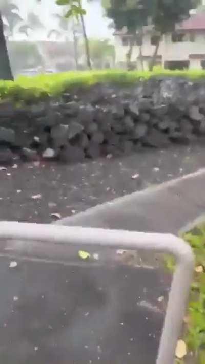 Waves crashing over houses in Hawaii