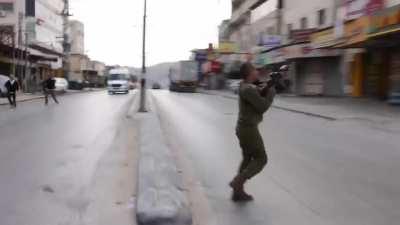 Israeli settlers, backed by the army, attack Palestinians in Hawara, West Bank.