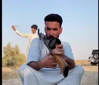 Open a bottle of water by AK-47.