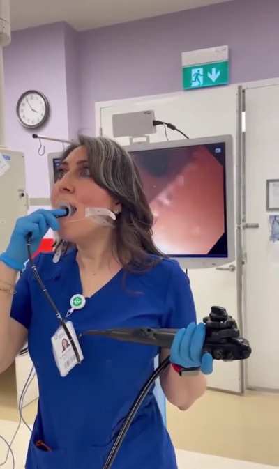 Doctor performs endoscopy on herself.
