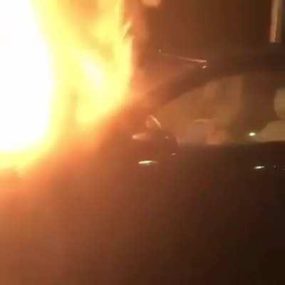 Guy sleeping in a car on fire