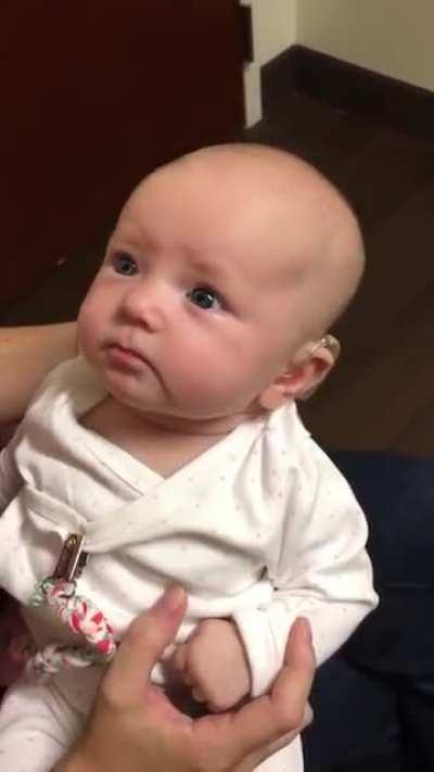 Baby hears mothers voice for the first time with the help of a hearing aid. the reaction is beautiful.
