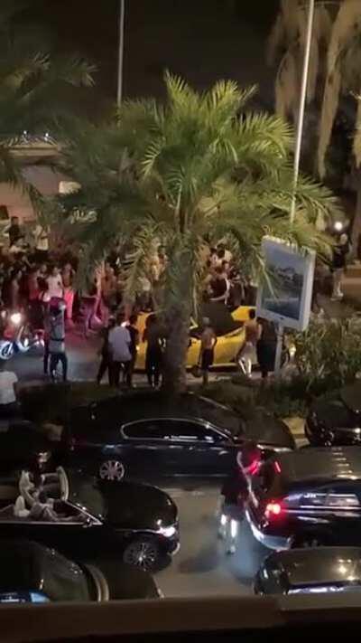 Hooligans jumping on a Lamborghini