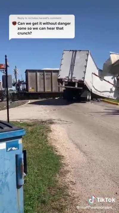 Trailer that gets stuck on the tracks takes a direct hit