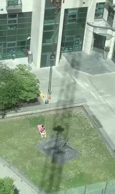 Crane operator messes with sunbathing dude