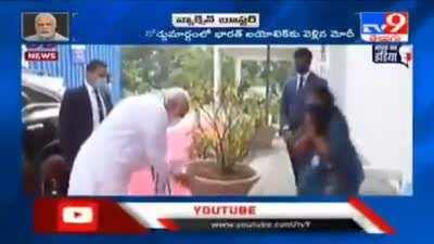 Respekt! Modi keeps nudging him till the guy touches his feet.