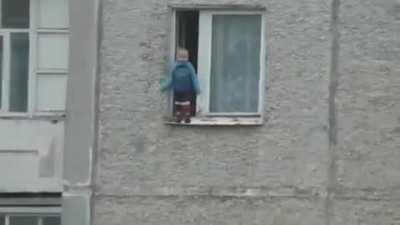 Russian kid hanging out the window for better view..