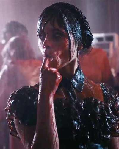 Jenna Ortega as Wednesday Adams sucking her finger.