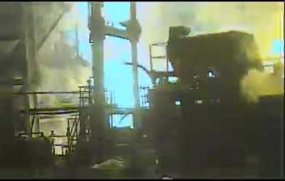 Throwing a water bottle into molten steel. (angle showing bottle throw by coworker in comments)