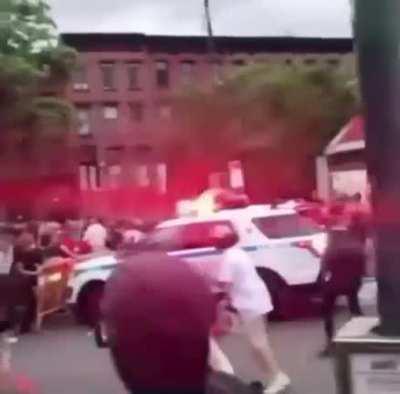 2 NYPD vehicles decide to just run everyone behind the barricades over.