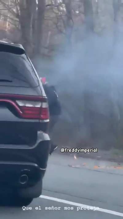 Bystanders try to help a motorcyclist who’s on fire after an accident