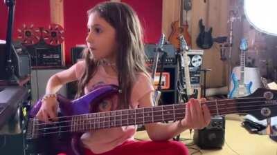 Little girl is playing some funky music