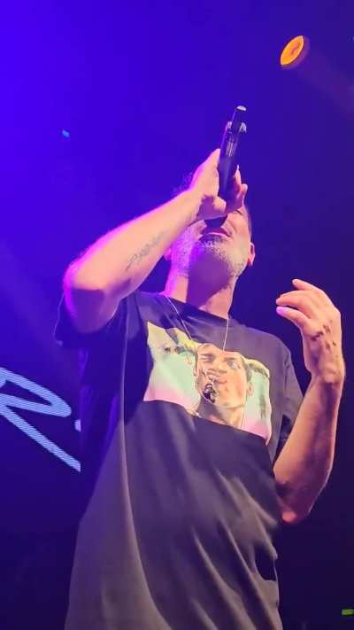 A singer performing live on stage.