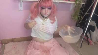 Pink haired girl vomits in her bowl