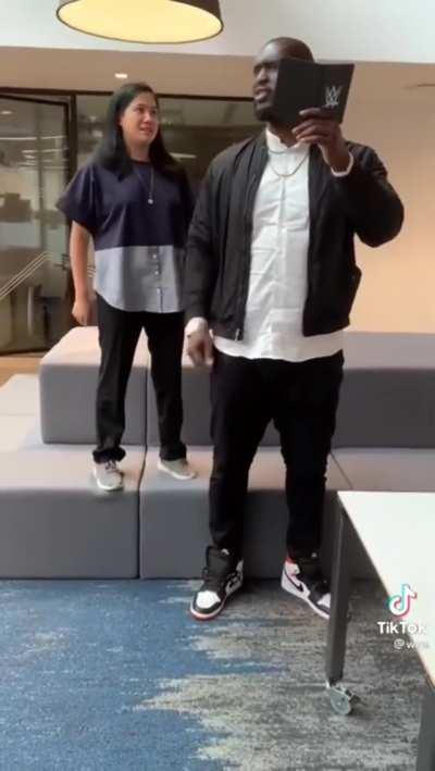 Omos being buddies with a regular sized WWE staff