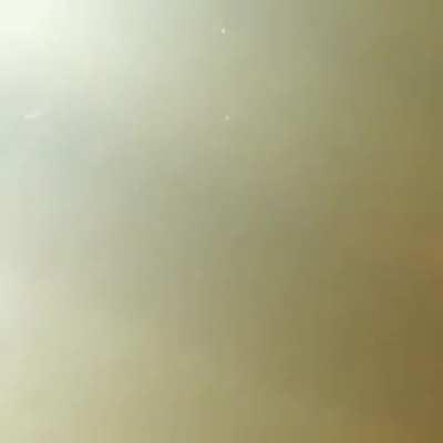 Woman looks over the edge of a waterfall, slips, and falls down.