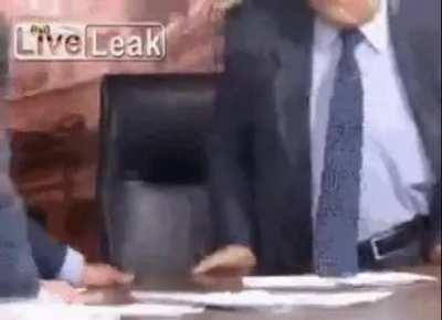 Angry Syrian opponents fight over a table.