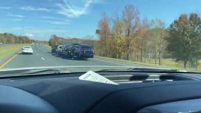 Truck pulling truck pulling trailer with cars with ratchet strap at 75mph.