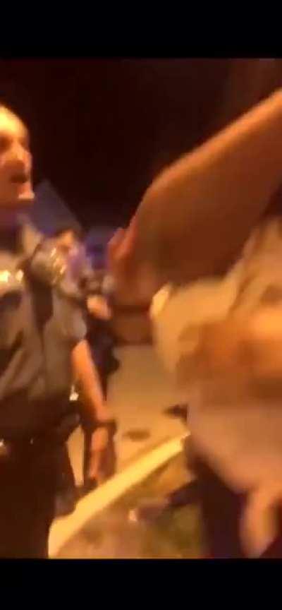 Kansas City officer putting his knee in the back of a pregnant woman while they force her to lie on the ground on her pregnant belly.