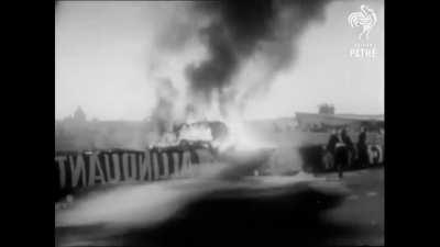 Footage of the 1955 Le Mans disaster that killed French driver Pierre Bouillin and 83 spectators. 180 others were also injured. The crash occurred after Boullin's car hit another car at 125 mph and cartwheeled into the stands, hitting dozens of people.