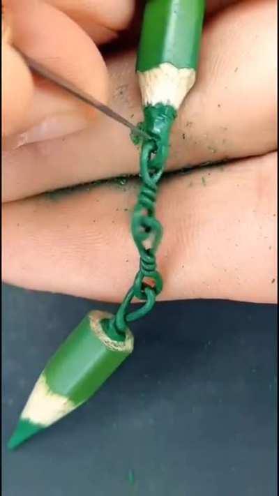 Carving a chain from a pencil.