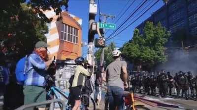 Seattle BLM protestor throws flashbang grenade back at police