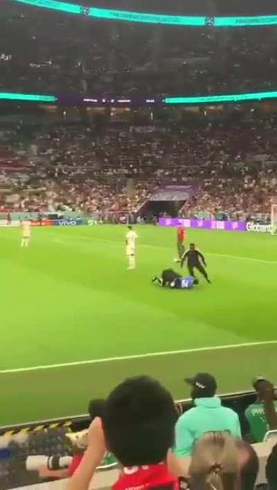 Man holding Pride flag runs through Uruguay v Portugal World Cup match