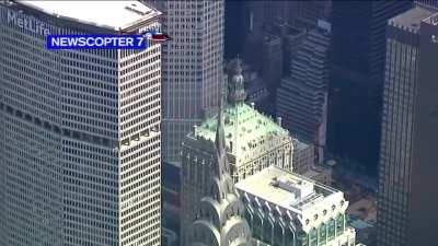 Newscopter spots workers climbing the tippy, TIPPY top of the Chrysler building