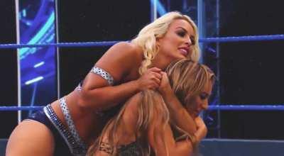 Mandy Rose applies a tight chin lock on Carmella