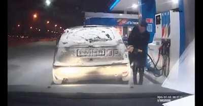 Woman uses lighter on frozen gas tank; lights gasoline