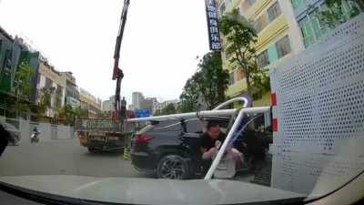 Man luckily survives after lamp post falls from crane and strikes him.