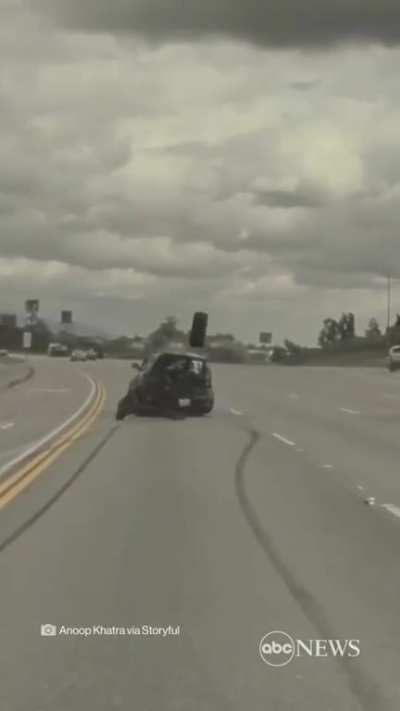 Car flies into the air after hitting a tire on the highway