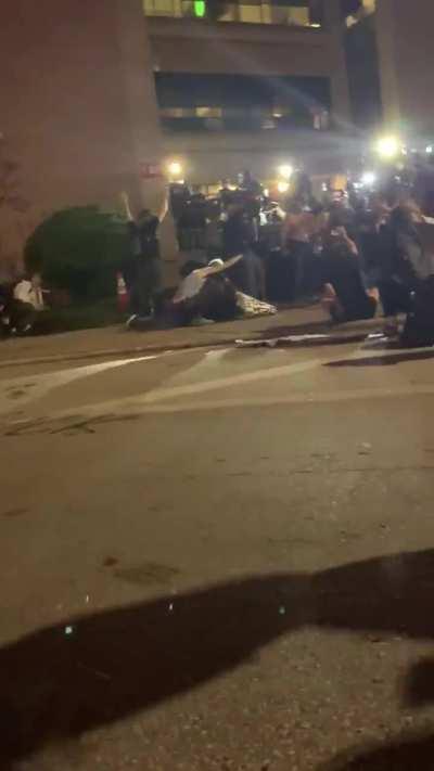 Protestor is shot in head with rubber bullet, knocked unconcious. Crowd tries to take him to the police for medical help, and they too are shot with rubber bullets. This is America.