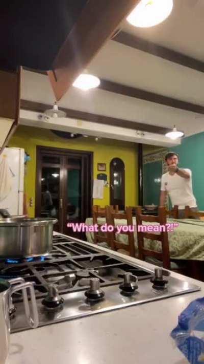 Breaking spaghetti in front of an Italian