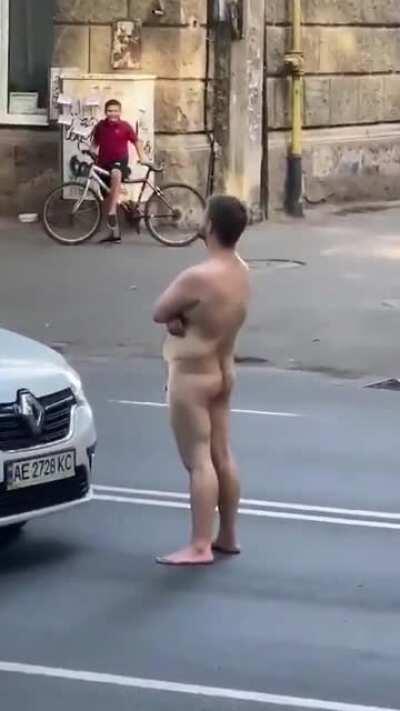 guy gets knocked out for standing naked on the road.